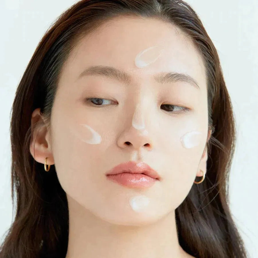 Woman applying Korean skincare cream on face, Me Time Groningen product demo