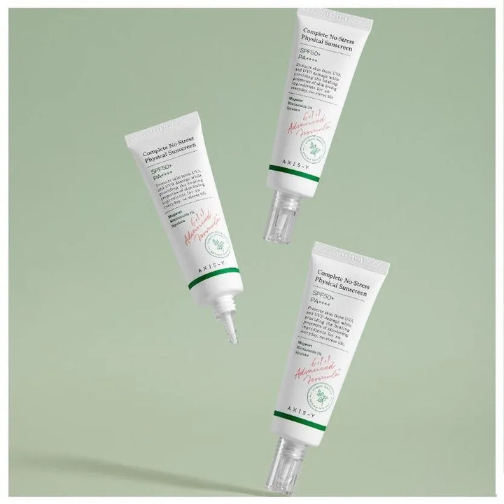 Three AXIS-Y Complete No-Stress Physical Sunscreen tubes on a green background, Korean skincare