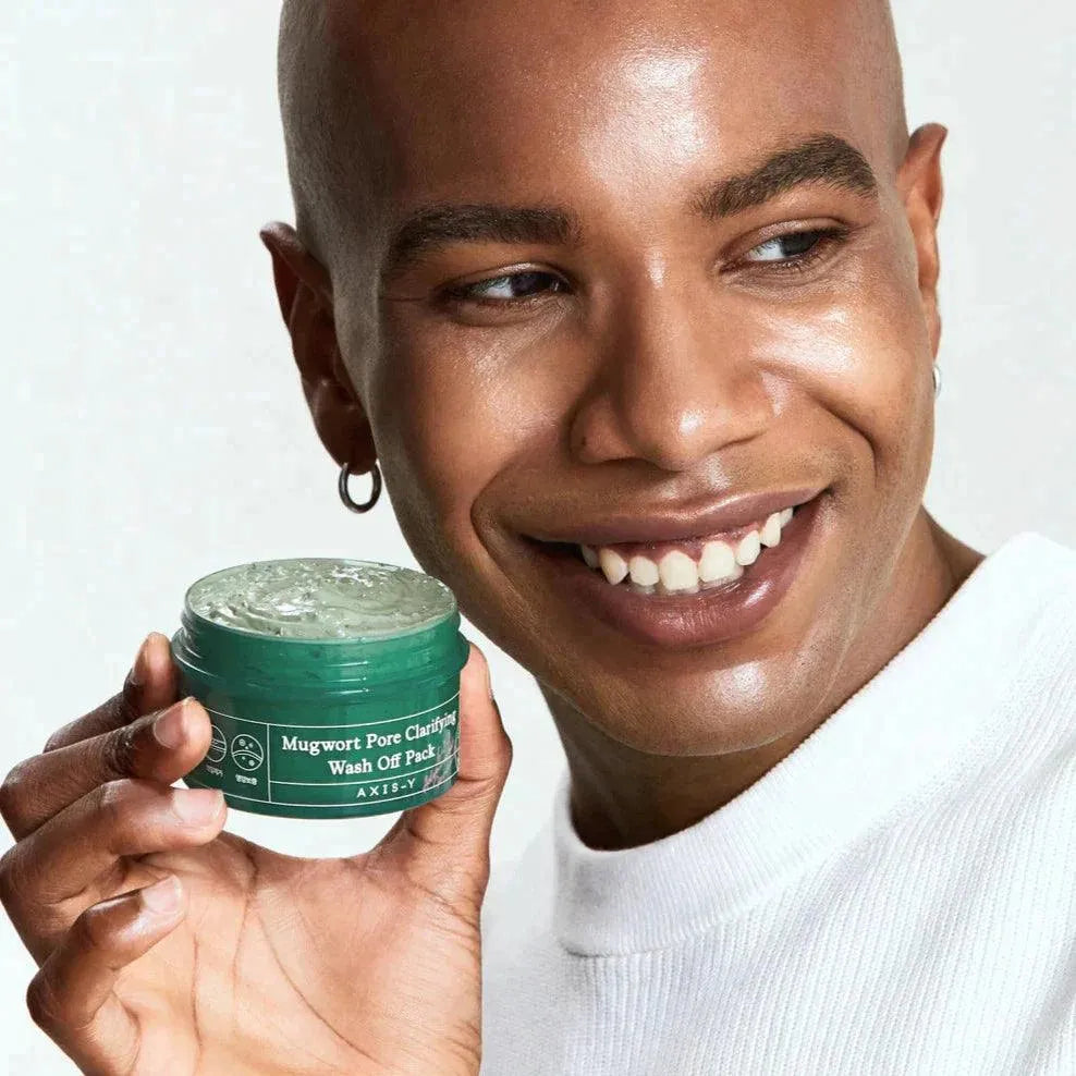 Smiling person holding Axis-Y Mugwort Pore Clarifying Wash Off Pack, Korean skincare