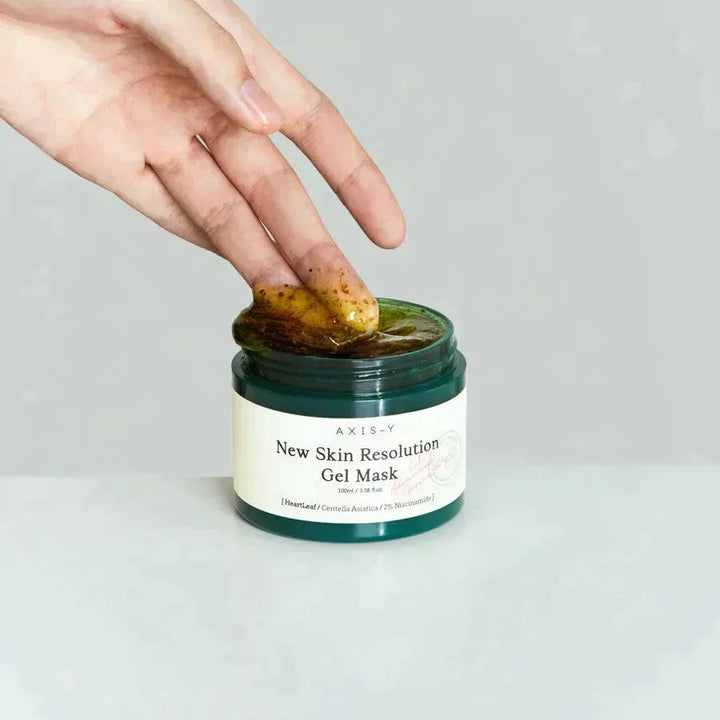Hand scooping AXIS-Y New Skin Resolution Gel Mask, Korean skincare product, on white background