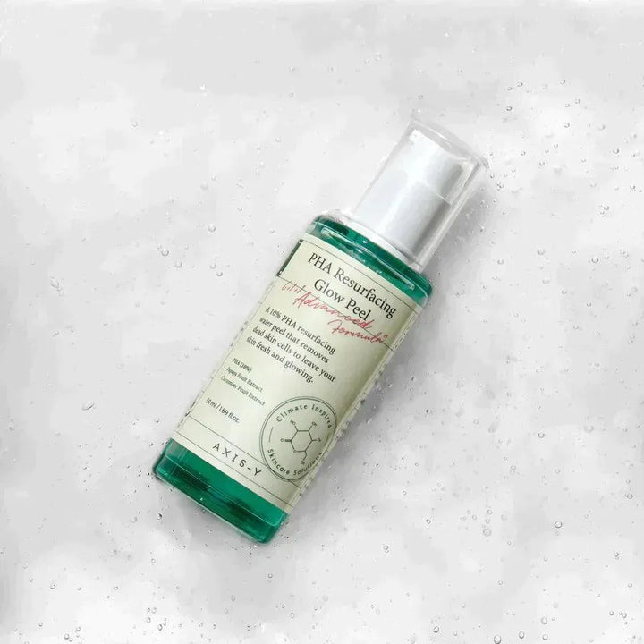 Axis-Y PHA Resurfacing Glow Peel Korean skincare bottle on wet textured surface