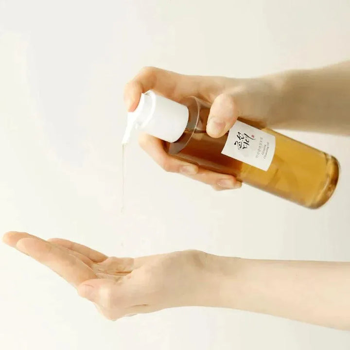 Dispensing Beauty of Joseon Ginseng Cleansing Oil, Korean skincare product, into hand