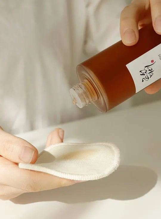Pouring Beauty of Joseon Ginseng Essence Water onto a cotton pad, Korean skincare Netherlands