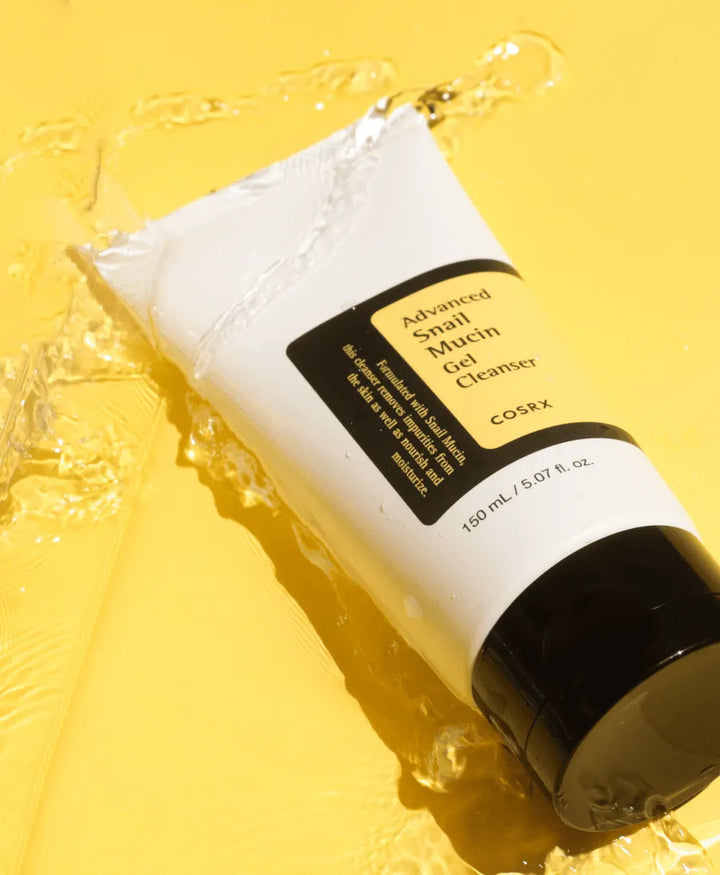 COSRX Advanced Snail Mucin Gel Cleanser tube on yellow background, Korean skincare product