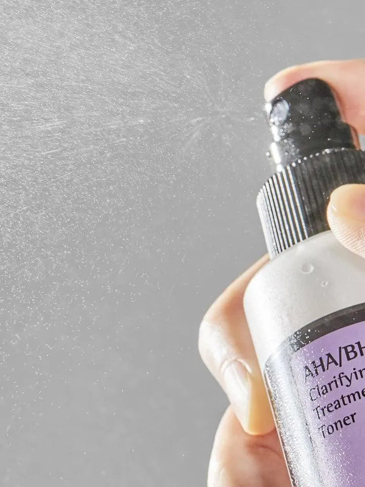 Hand spraying COSRX AHA/BHA Clarifying Treatment Toner, Korean skincare Netherlands product.