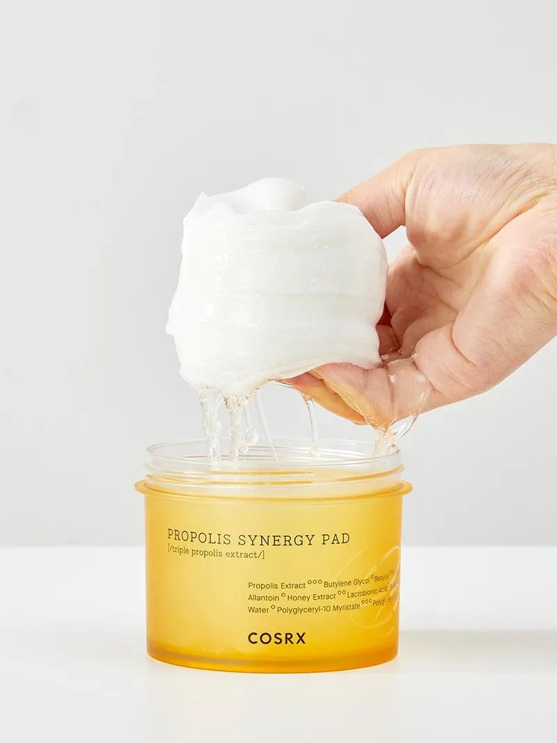 Hand lifting soaked COSRX Propolis Synergy Pad from jar for Korean skincare, Me Time Groningen