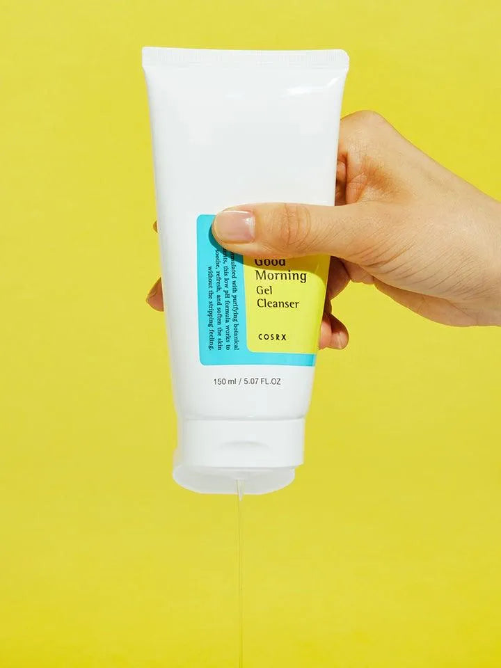 Hand holding COSRX Low pH Good Morning Gel Cleanser, Korean skincare product, yellow background