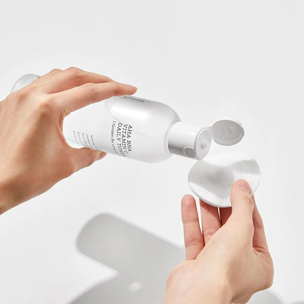 COSRX Refresh AHA BHA Vitamin C Daily Toner bottle poured onto cotton pad, Korean skincare