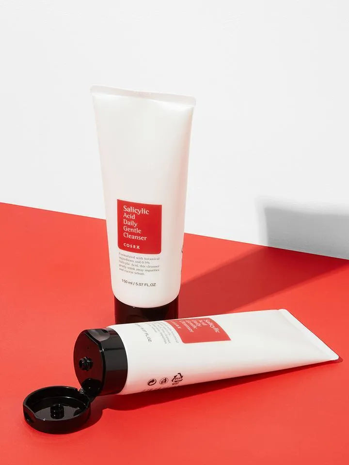 COSRX Salicylic Acid Daily Gentle Cleanser tubes on red and white surface, Korean skincare Nederland