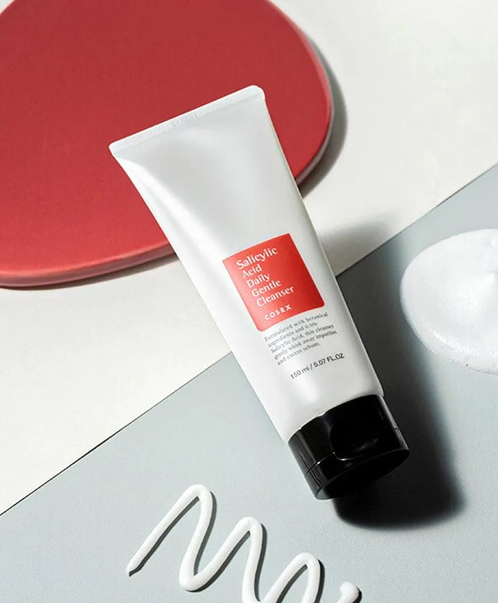 COSRX Salicylic Acid Daily Gentle Cleanser Korean skincare tube on flat lay with foam, Me Time Groningen