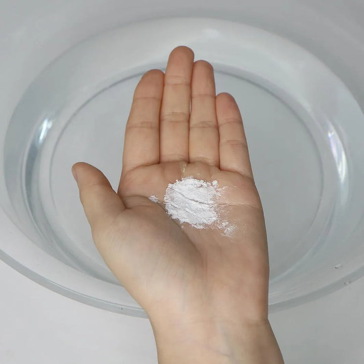 Hand holding Dr. Ceuracle Pro Balance Morning Enzyme Wash powder for Korean skincare