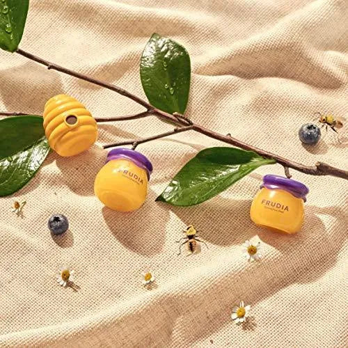 Frudia Blueberry Hydrating Honey Lip Balm jars with honeycomb and bees on fabric, Korean skincare Me Time Groningen