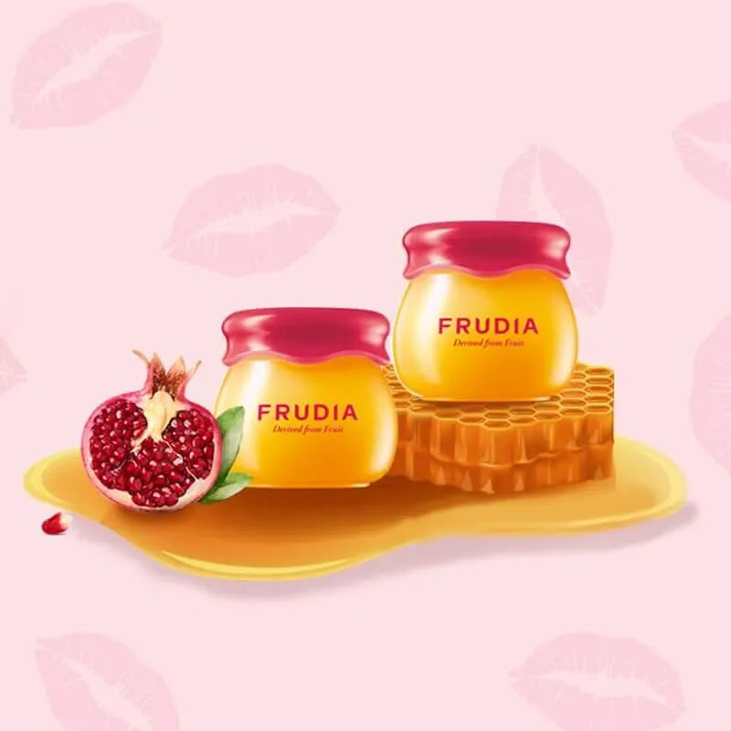 Frudia pomegranate honey 3-in-1 lip balm jars with pomegranate and honeycomb on pink background