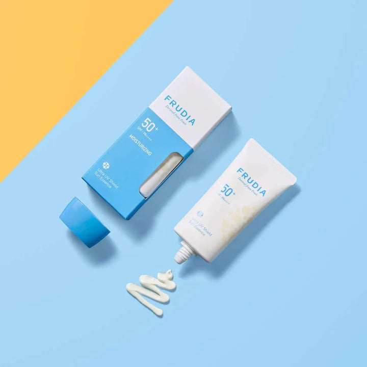 Frudia Ultra UV Shield Sun Essence SPF 50+ Korean sunscreen on blue-yellow background, Me Time Groningen