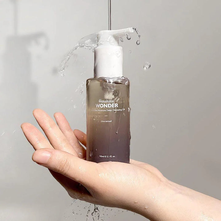 Haruharu Wonder Black Rice Moisture Deep Cleansing Oil held in hand with water splashing, Korean skincare product Netherlands