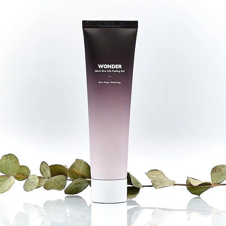 Haruharu Wonder Black Rice Soft Peeling Gel tube on white background with green leaves, Korean skincare Me Time Groningen