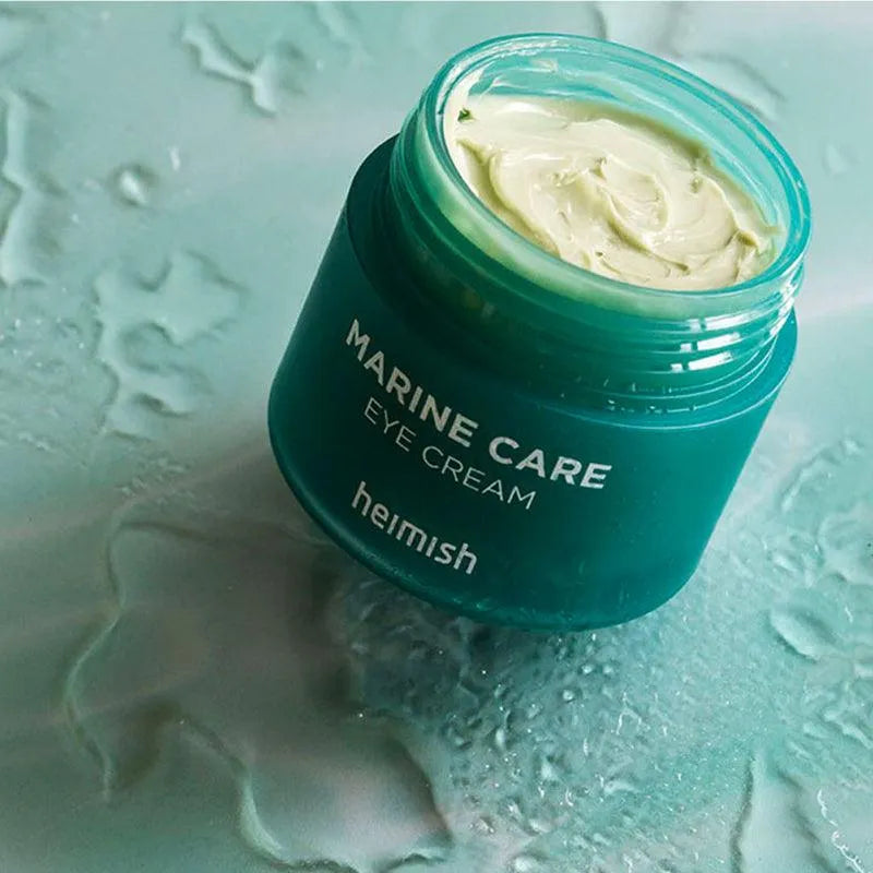 Heimish Marine Care Eye Cream jar on wet aqua surface, Korean skincare at Me Time Groningen