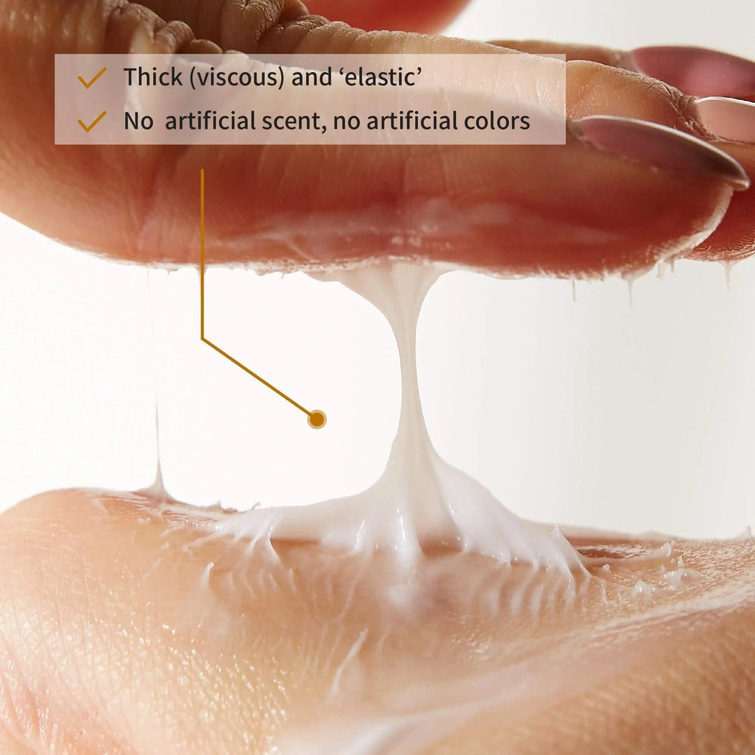 Close-up of iUNIK Black Snail Restore Cream texture, thick and elastic, on fingers, Korean skincare from Me Time Groningen.