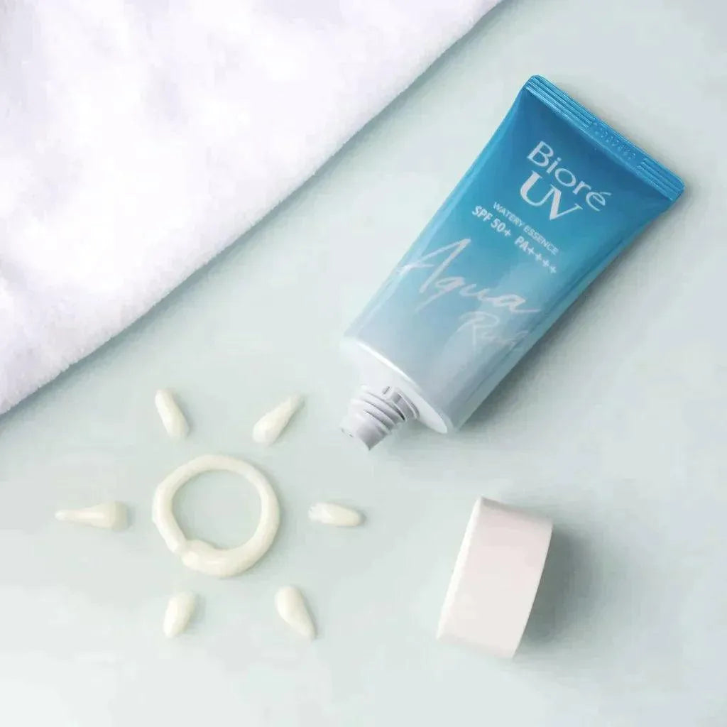Biore UV Aqua Rich Watery Essence SPF 50 tube with sunscreen sun design on white surface