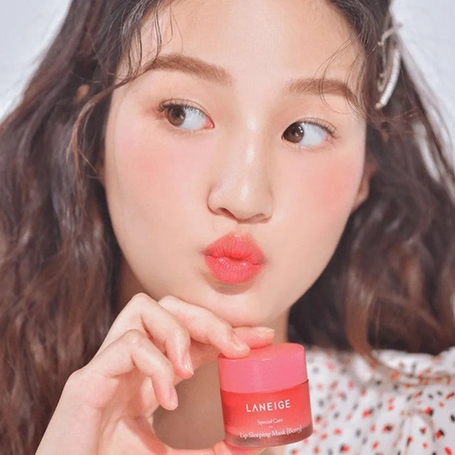 Young woman with glowy skin holding Laneige Lip Sleeping Mask Berry, Korean skincare product