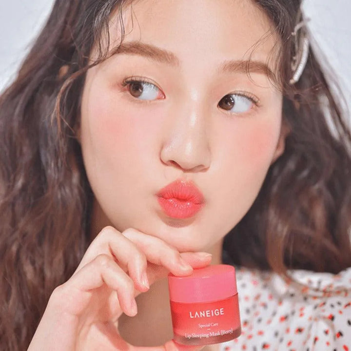 Young woman with glowy skin holding Laneige Lip Sleeping Mask Berry, Korean skincare product
