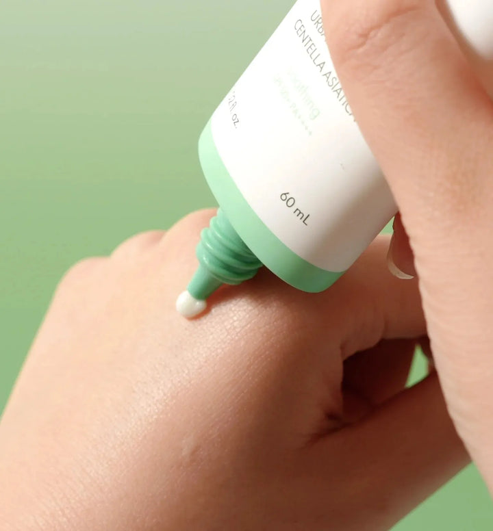 Applying Korean skincare cream from a green and white tube onto hand, Me Time Groningen