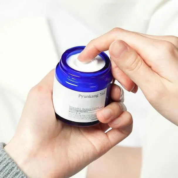 Hand dipping into Pyunkang Yul Intensive Repair Cream, Korean skincare at Me Time Groningen
