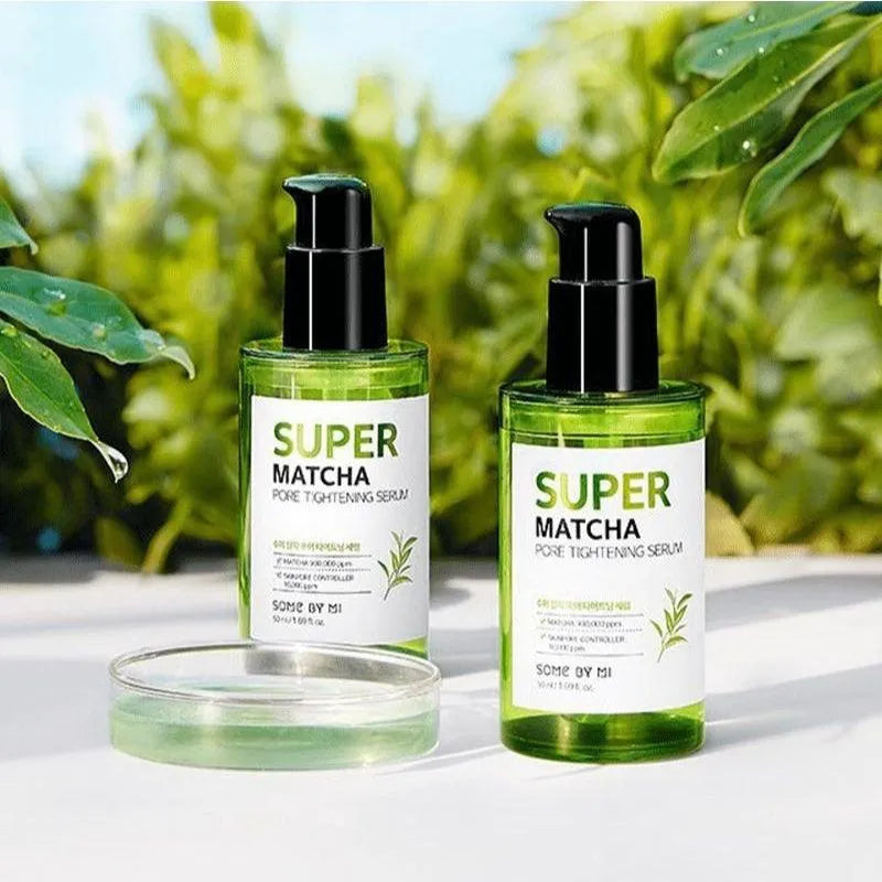 Two bottles of SOME BY MI Super Matcha Pore Tightening Serum on a white surface with green leaves, Korean skincare Me Time Groningen.