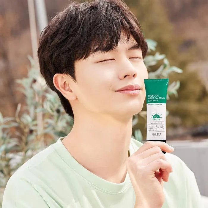 Man holding Some By Mi Truecica Aqua Calming Sun Cream outdoors, Korean skincare Netherlands